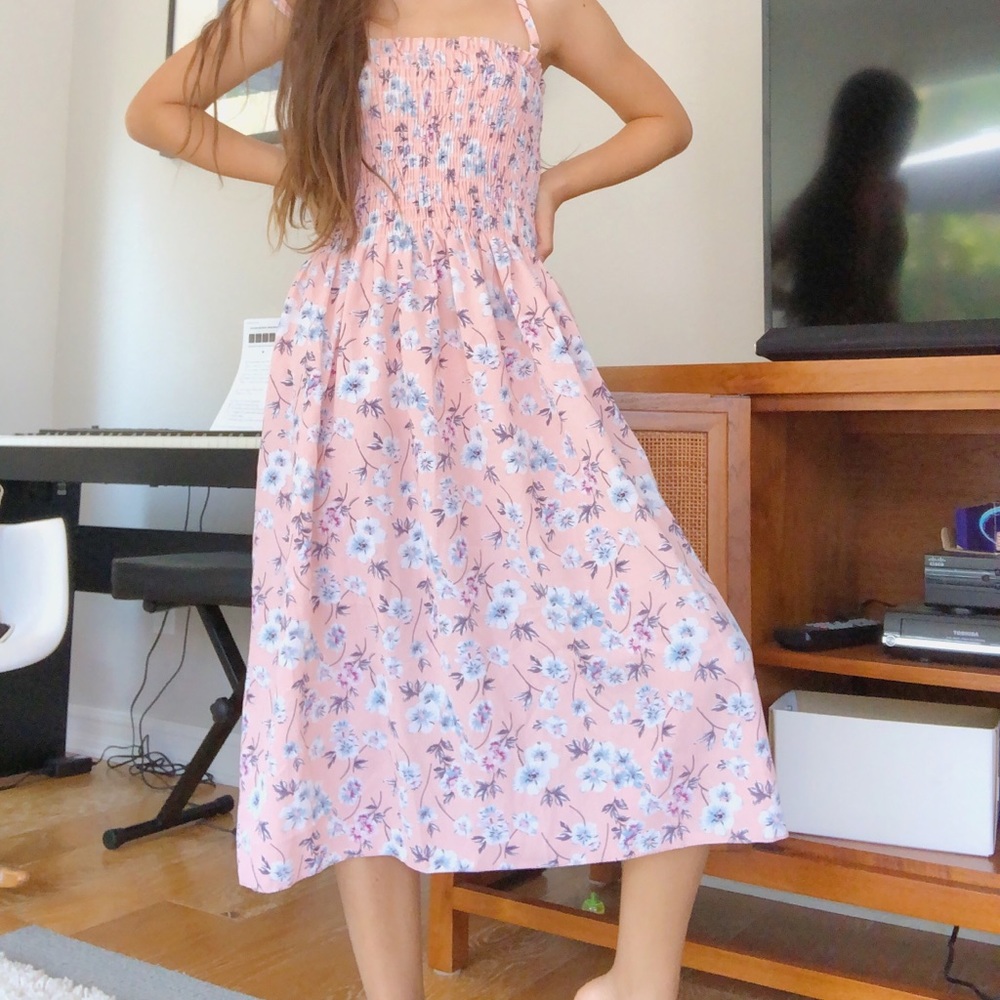 this is a long pink dress with a flower pattern